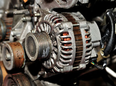 Close-up of an alternator mounted in a car's engine bay
