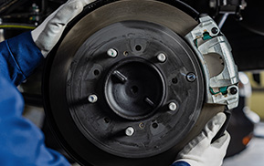 Mechanic inspecting a brake rotor and caliper