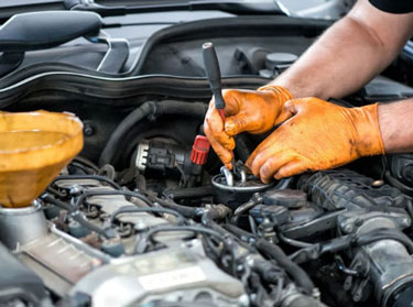 Mechanic in work gloves repairing an engine