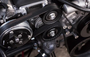 Close-up of an engine belt and pulleys