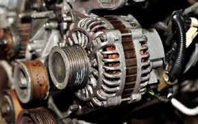 Close-up of an alternator mounted on an engine