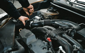 Mechanic working in an open engine bay