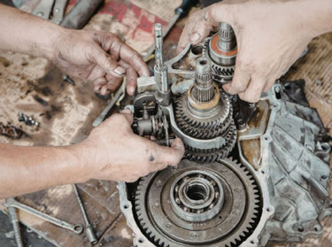 Mechanic rebuilding a transmission gear set